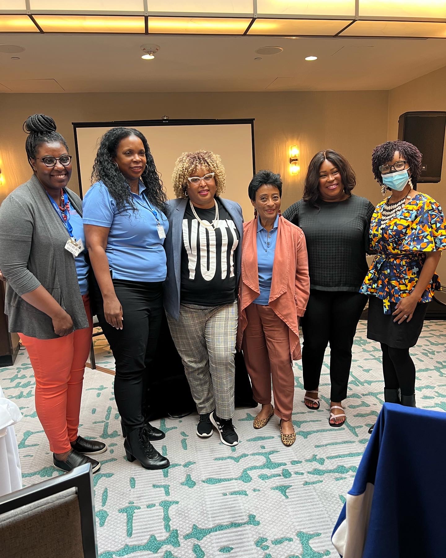 Natalie James with a group of women organizers, one wearing a VOTE shirt