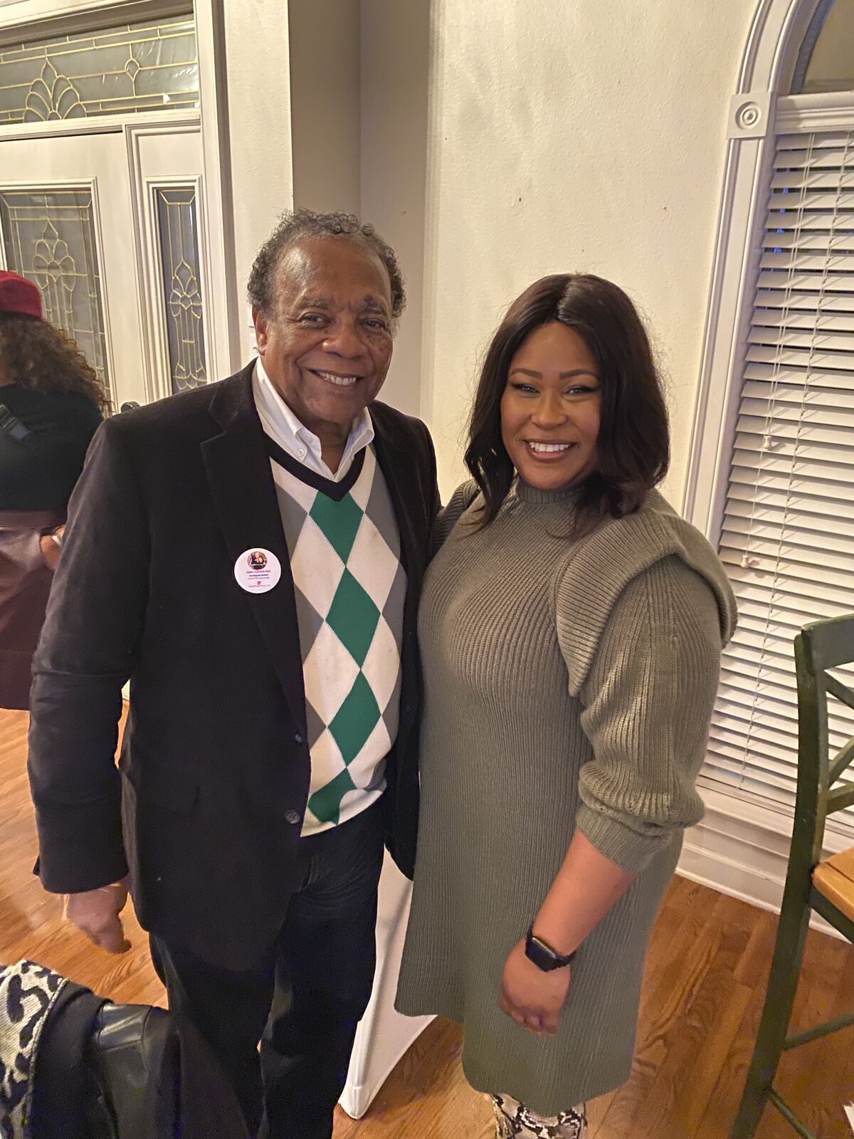 Natalie James with a longtime community leader at an evening campaign gathering