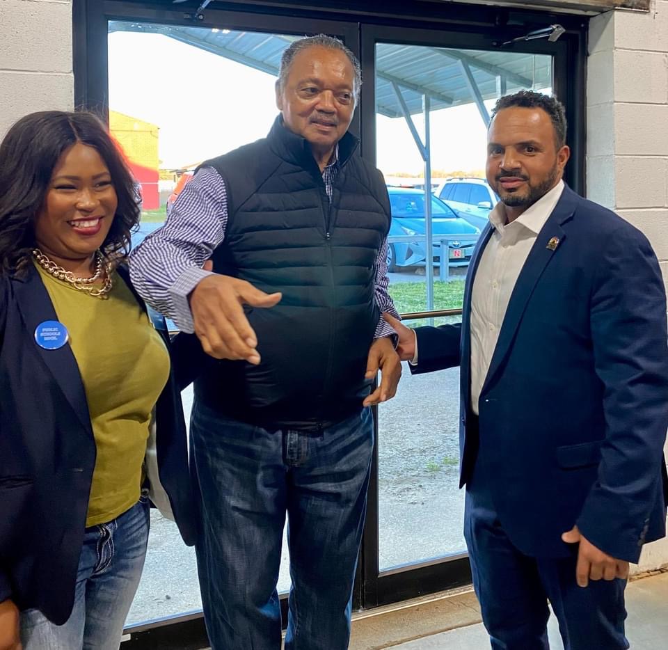 Natalie James with Rev. Jesse Jackson and a community leader at an Arkansas community event