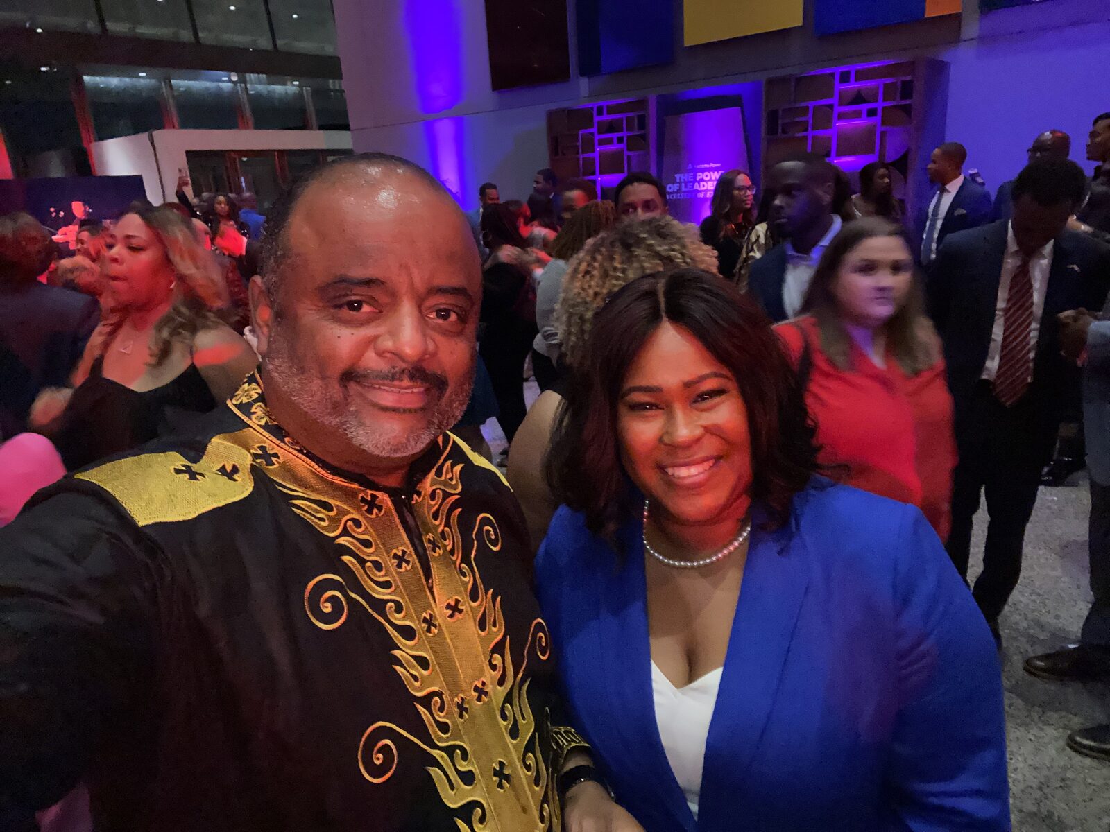 Natalie James with journalist Roland Martin at a leadership event
